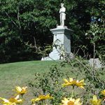 Spring Statue with Flowers in Front