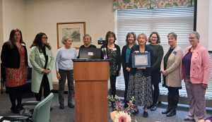 Volunteers from Dementia Friendly Sudbury hold a certificate from the statewide Dementia Friendly Massachusetts which acknowledges the local organization's work.